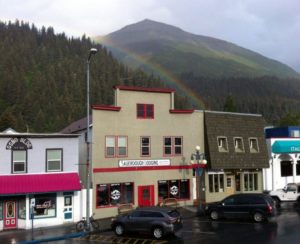 Sauerdough Lodging and the Sea Bean Cafe, with a rainbow-shrouded Mount Marathon behind. Photo: Stock